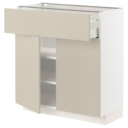 A white METOD kitchen cabinet with beige doors and shelves. It has a modern design with a smooth finish and clean lines.