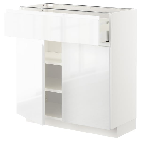 High gloss white METOD cabinet with shelves and drawers, sleek modern design.