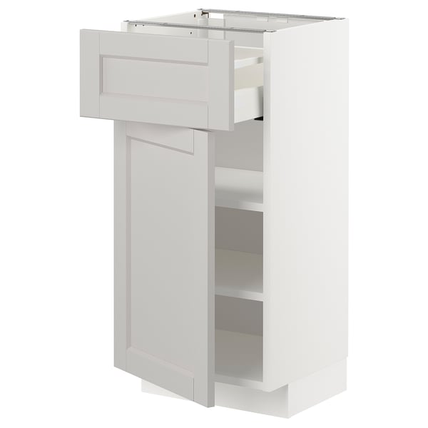 A white METOD kitchen cabinet with a pull-out shelf and a drawer, featuring grey lerhyttan fronts with beveled edges.