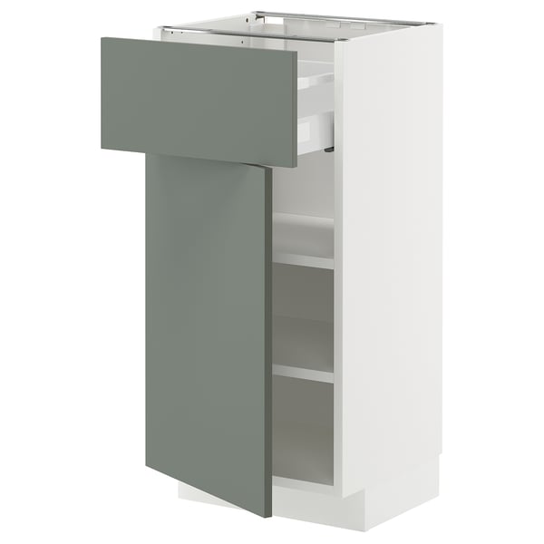 METOD kitchen cabinet with grey-green drawer & white shelves.