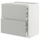 Light grey METOD kitchen cabinet with three drawers, sleek modern design.