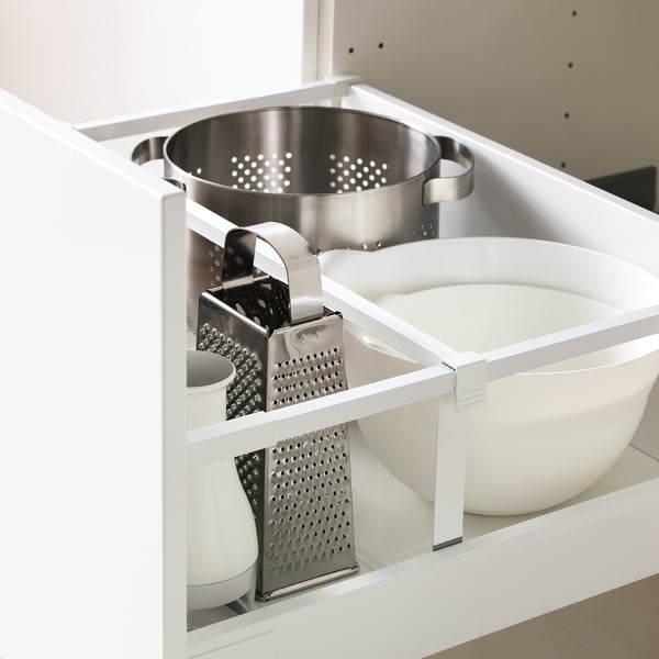 A kitchen drawer with three graters and two plastic bowls, part of the METOD storage system.