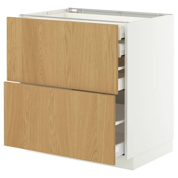 A METOD kitchen cabinet in white and light wood. It has both drawers and shelves.