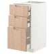 A white METOD kitchen cabinet with three light bamboo drawers. It modern design and self-closing drawers.