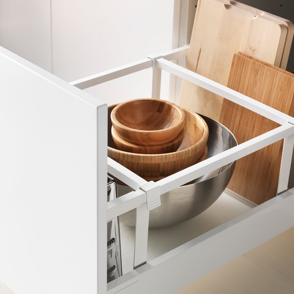 Open kitchen drawer with bowls and pots