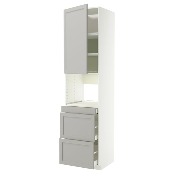 White METOD kitchen unit: tall cabinet with open door, two grey drawers, modern design.