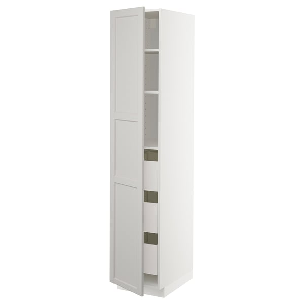 A white METOD kitchen cabinet. Its tall, rectangular, with one door open revealing shelves and drawers inside. The design is minimalist and modern.