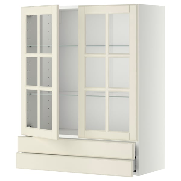 Off-white METOD kitchen cabinet with glass doors and drawer.