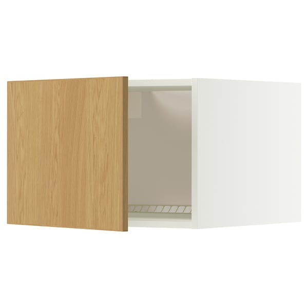 A white METOD kitchen cabinet with a light wood door slightly ajar. It a flat panel design and snap-on hinges.
