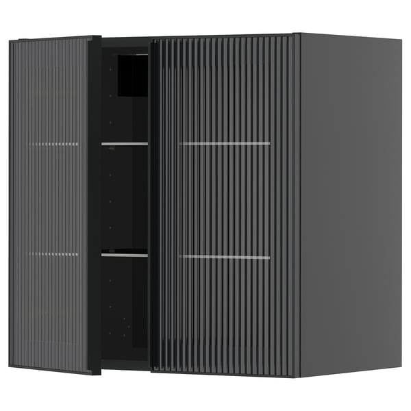 Black kitchen cabinet with reeded glass and metal handles.