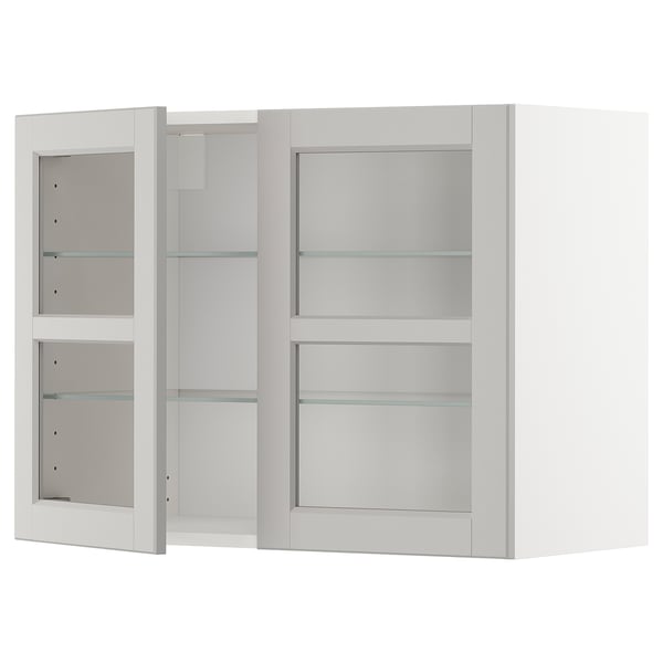 White METOD kitchen cabinet with glass doors and shelves.