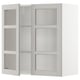 White wall-mounted kitchen cabinet with glass doors, featuring adjustable shelves.