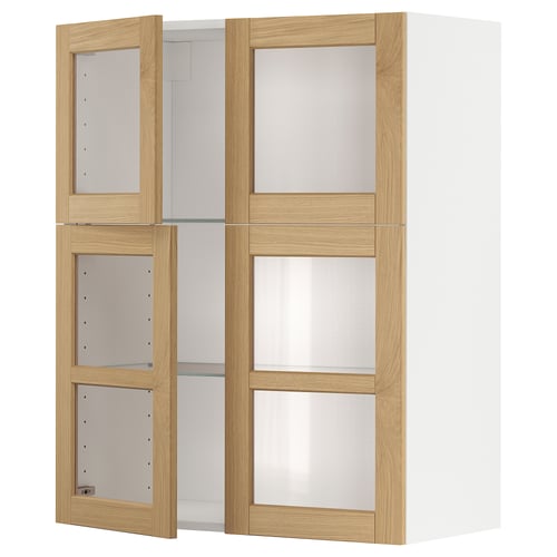 An ikea METOD wall cabinet with light oak veneer doors and frosted glass panels. The cabinet has two open sections and is white in color.