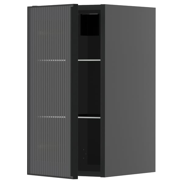A dark gray METOD kitchen cabinet with a glass door featuring vertical grooves and a sleek metal frame.