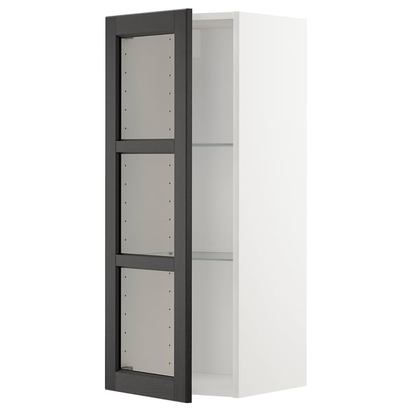 White METOD kitchen cabinet with black stained frame and glass shelves.