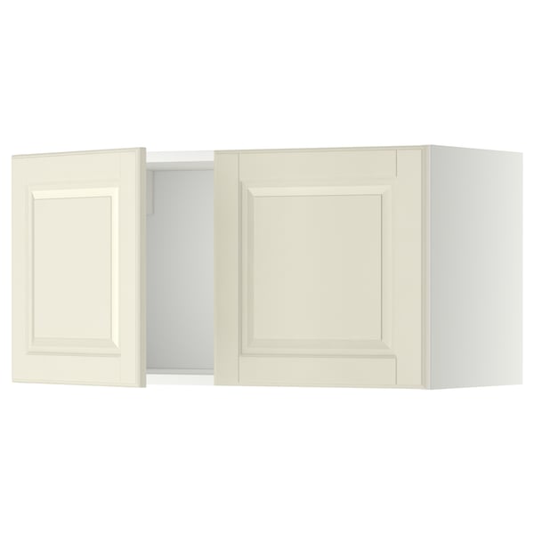 Two white METOD kitchen wall cabinets with bevelled doors.