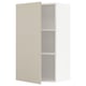A beige METOD kitchen cabinet with a white interior and two shelves. The cabinet door is closed, and the design is sleek and modern.