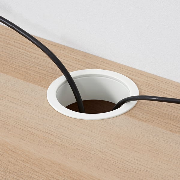 Round desk cable tray holds cords, keeping workspace neat.