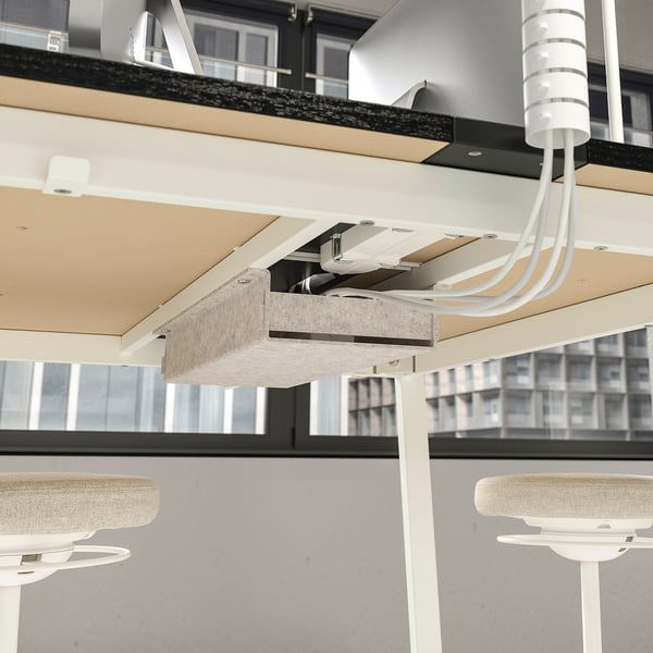 Office cubicles with suspended power cables and led light panels. Cables perfectly aligned, connecting multiple workstations.