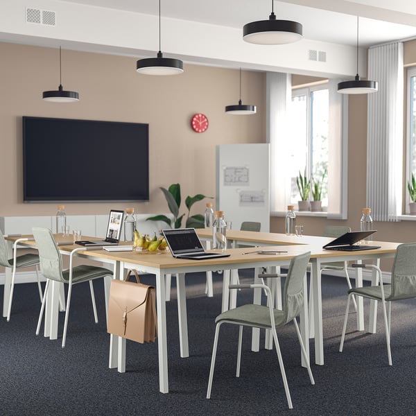 MITTZON conference table, light wood, modern design, large rectangular shape, ideal for meetings, surrounded by green chairs.