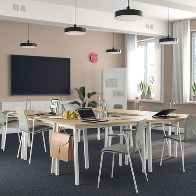 MITTZON conference table, light wood, modern design, large rectangular shape, ideal for meetings, surrounded by green chairs.