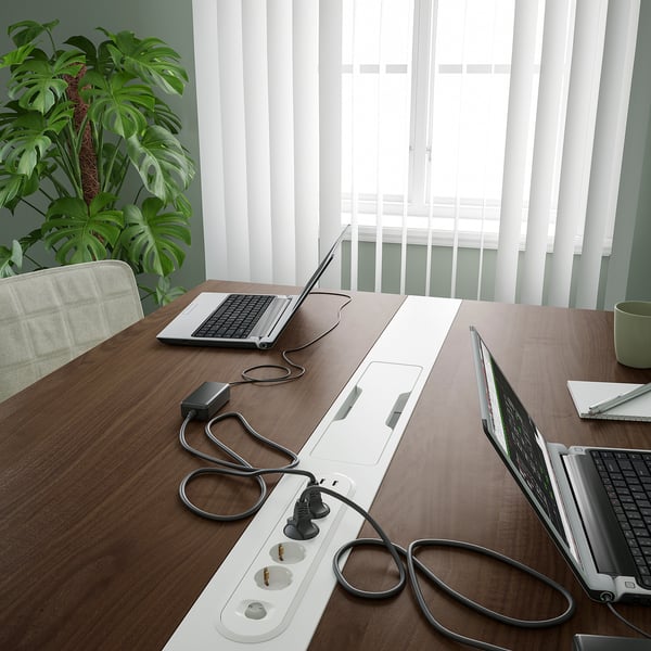 Conference table with built-in cable management and laptop spots.