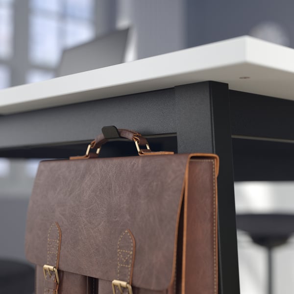 Close-up of MITTZON high tables cable management hole for organising cords.