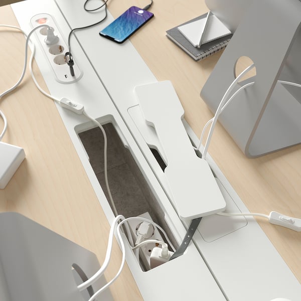 Desk with built-in cable management compartment, power outlet, and smart device charging areas.