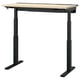 Modern black standing desk with light wood top, adjustable.