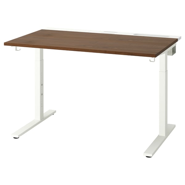 The MITTZON desk in walnut has a rectangular brown wooden top and sturdy white legs. Its simple and modern.