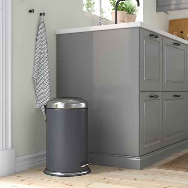 Grey MJÖSA bin fits under kitchen counter, stainless steel, round, soft-close lid.