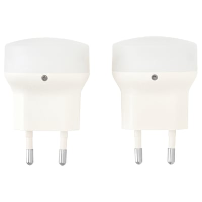 Two white, compact, plastic nightlights with automatic sensors.
