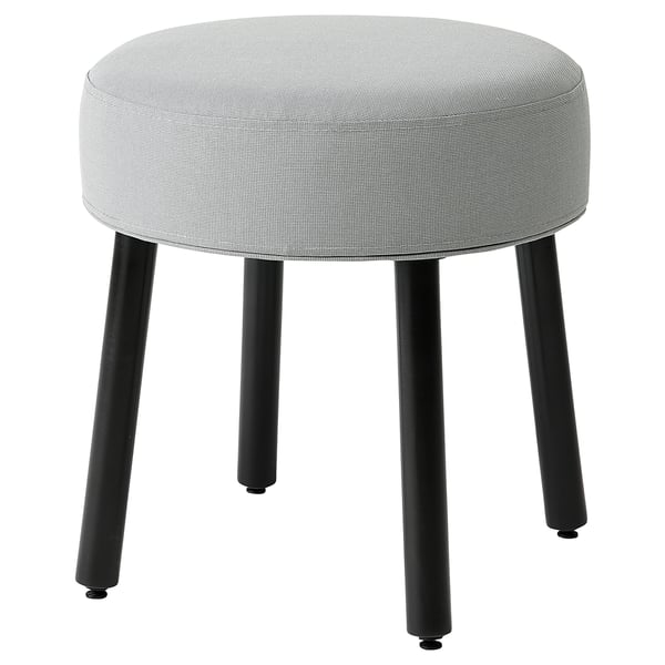 Round, grey fabric stool with black metal legs, stylish and versatile seat.