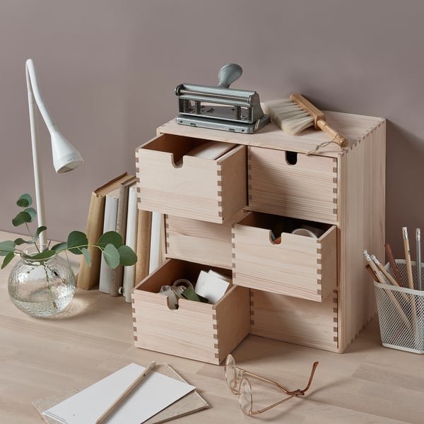 Wooden multi-drawer MOPPE organiser with office supplies, plants, and necklace holder.