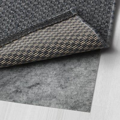 This image shows a folded MORUM rug, designed for durability and easy cleaning, ideal for high traffic areas.