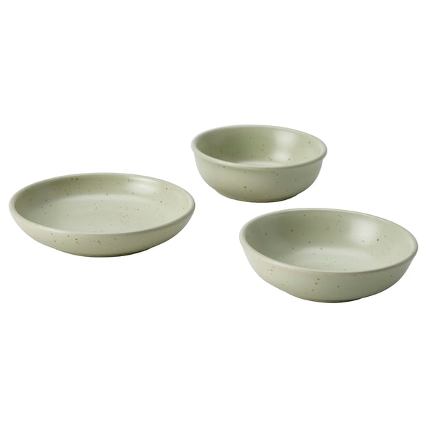 Three light green speckled stoneware bowls in different sizes arranged in a triangle.