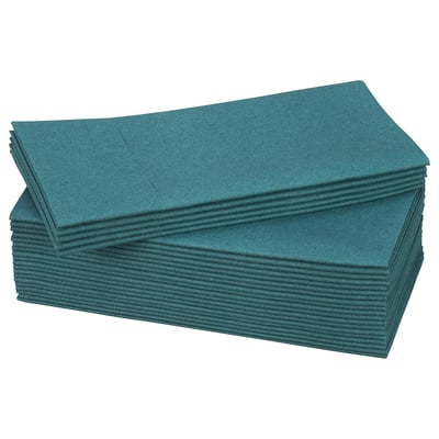 Stacked green paper napkins, neatly folded, rectangular shape.