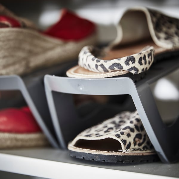 Display of leopard print sandals on grey MURVEL shoe storage racks.