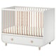 A white and light wood MYLLRA cot with a drawer for a babys room.