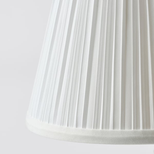 This image shows a close-up of a white pleated lampshade, highlighting its smooth, even texture and modern design.