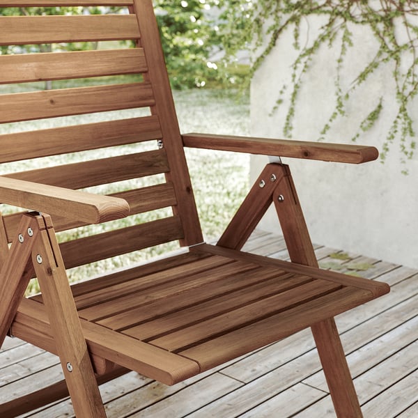 Brown wooden NÄMMARÖ chair, foldable, acacia wood, outdoor use, slatted design.
