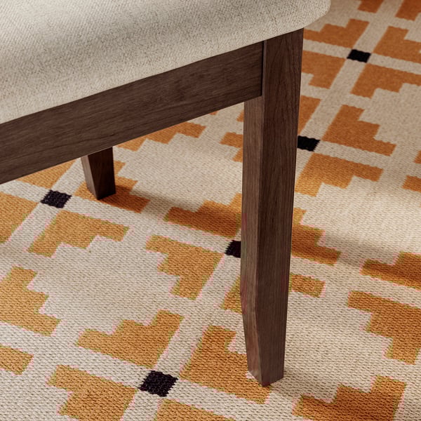 Close-up of modern chair leg, sleek finish, solid wood, stylish design.