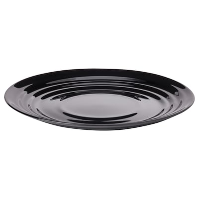A black NÄTBARB dish, round in shape, made of tempered glass with a glossy, opaque surface showcasing a ripple pattern.