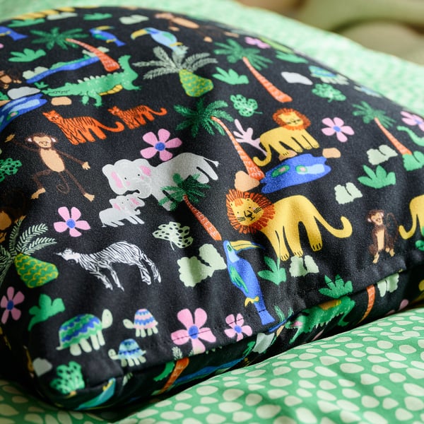 Vibrant, eco-friendly cushion cover with recycled polyester, featuring a playful jungle design, ideal for kids rooms.