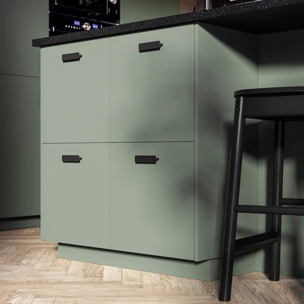Modern kitchen cabinet with smooth grey-green finish and black handles.