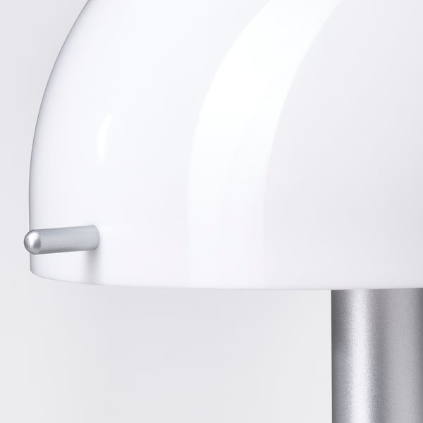 Close-up of sleek, white, modern lamp with smooth finish and metallic handle.