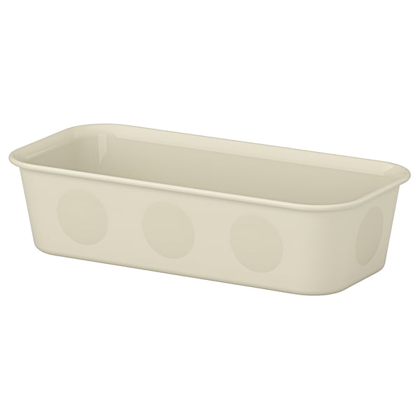 A beige NOJIG organiser box. Its rectangular, made of recycled plastic, and circular cutouts on the sides.