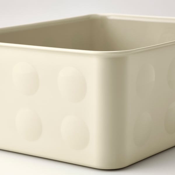 Off-white plastic storage box with textured, embossed circles. Sturdy for organising items.