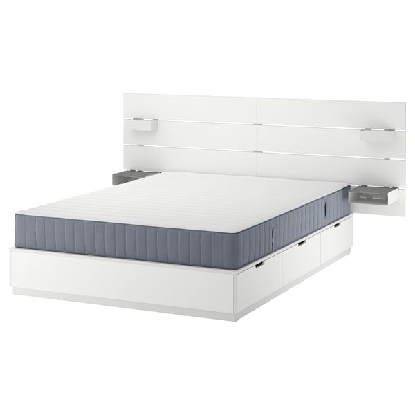 Modern white bed frame with grey mattress, sleek design, storage drawers, wall-mounted headboard.