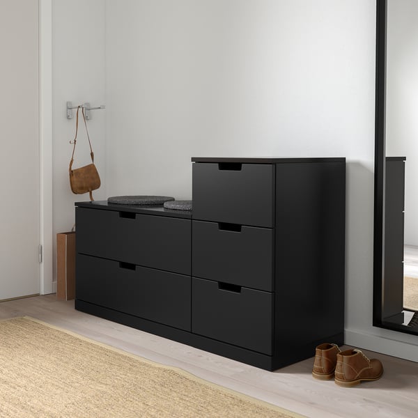 Black NORDLI 6-drawer chest fits narrow spaces, with modern design, smooth-closing drawers, and adjustable feet for uneven floors.